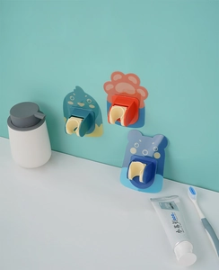 Close-up of cartoon-themed shower head holders in bird, bear, and paw shapes