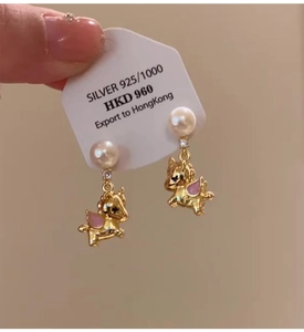 Detail view of 925 silver unicorn pearl earring with pink enamel and sparkling zircon