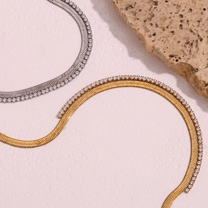 Detail of gold and silver fishbone chain necklace with micro-pave cubic zirconia inlay