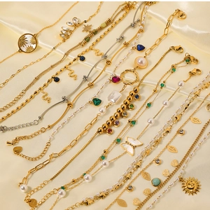 Detail of vintage gold plated jewelry set with natural stones and butterfly charms