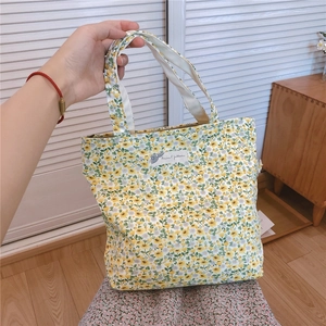 Detailed view of floral cotton handbag with Animal Patterns label and sturdy handles