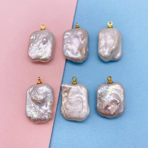 Detailed view of six irregular baroque freshwater pearls with golden ring connectors