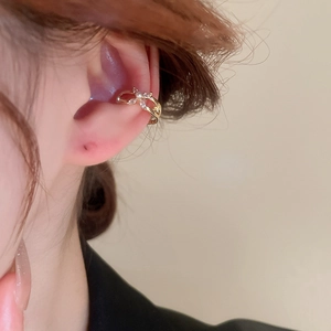 Close-up of gold-plated petal ear cuff with white zircon and pearl details on ear