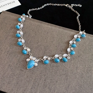 Macro view of vintage silver alloy necklace featuring turquoise water drop pendant details