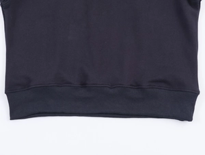 Close-up detail of high-elastic ribbed hem on dark cotton knit sweatshirt fabric