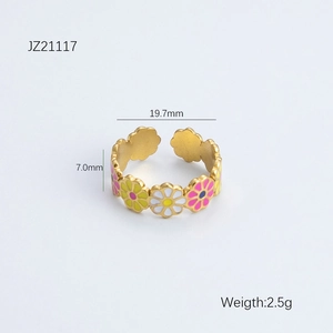 Macro detail of adjustable gold floral ring with colorful enamel daisy petals