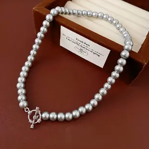 Elegant grey pearl beaded necklace featuring a metallic OT toggle clasp on leather