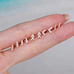 Rose gold stainless steel geometric stud earring set with zircons shown on hand