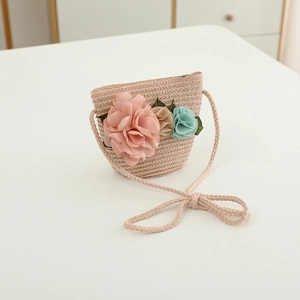 Detail of mini straw crossbody bag with three colorful fabric flowers for kids