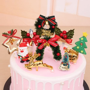 Festive Christmas cake toppers featuring Santa, golden reindeer, and green tree decorations