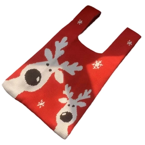 Red knit Christmas tote bag with white reindeer and snowflake patterns on white background