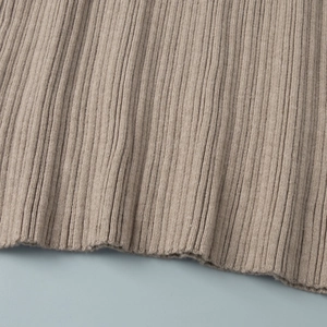 Detailed view of the ribbed knit hem texture on this off-shoulder midi dress