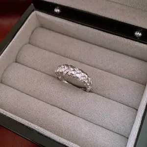 Vintage silver twist ring with zircon inlay on a velvet jewelry box display