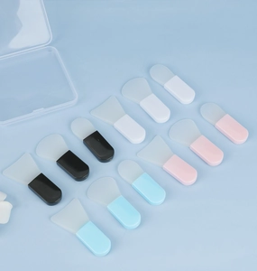Detailed set of 12 silicone face mask brushes in a clear plastic storage container