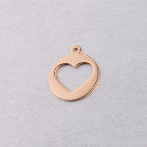 Detail of rose gold hollow heart pendant for DIY jewelry making with smooth finish