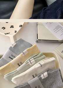 Detail of five assorted pastel cotton socks with ribbed texture in a lifestyle display