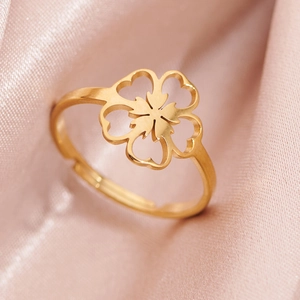 Adjustable golden clover ring in stainless steel with hollow daisy flower design on pink silk