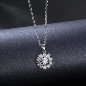 Elegant silver snowflake necklace with sparkling zircon pendant on textured dark background