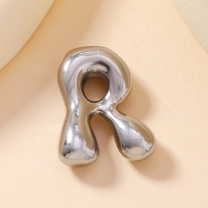 Detailed view of a silver bubble-style metal letter R pendant with glossy finish