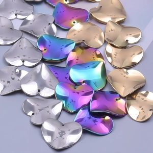 Vue macro de pendentifs en forme de cœur en acier inoxydable doré, argenté et arc-en-ciel