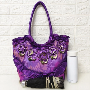Detail of purple silk tote bag showing large capacity with umbrella and thermos