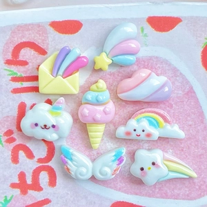 Close-up of pastel resin charms including rainbow clouds, unicorns and ice cream treats