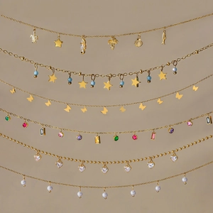 Detailed display of six gold stainless steel necklaces with ocean and nature themed pendants