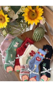 Flat lay of colorful mink velvet socks with cute fruit patterns and plush texture