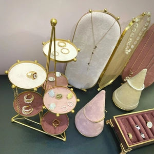 Elegant tiered jewelry display set in gold metal and velvet for rings and necklaces