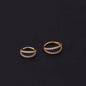 Detail of gold seamless nose rings with double rows of sparkling cubic zirconia stones