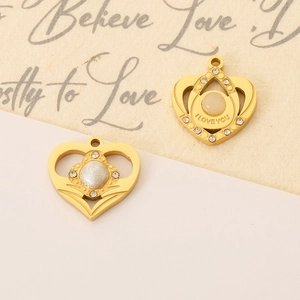 Detail of golden heart pendants with I Love You engraving and sparkling crystal accents