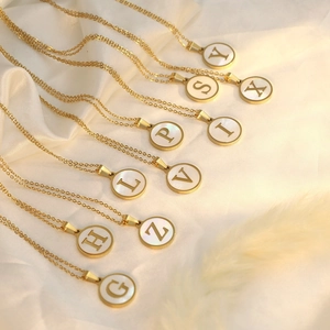 18K gold plated stainless steel initial necklaces on white silk with shell pendants