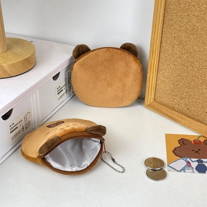 Cute brown plush Capybara coin purse with zipper closure on a cozy desktop setting