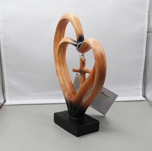 Detail of interlocking wooden hearts with a cross and a motivational scripture quote
