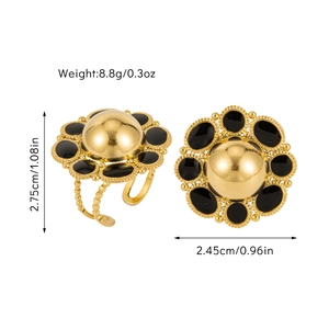 Detail view of vintage gold-plated floral ring with black enamel petals and beads