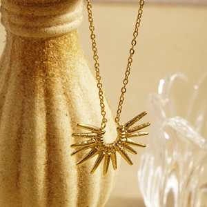 Elegant gold stainless steel sunflower necklace with geometric sunburst pendant