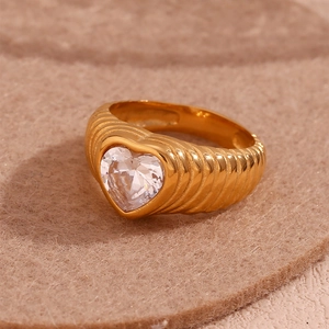 Close-up of 18K gold plated ring with heart-shaped zircon and grooved texture band