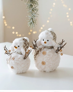 Detail of plush Christmas snowmen with vintage pattern hats and faux twig arms decor