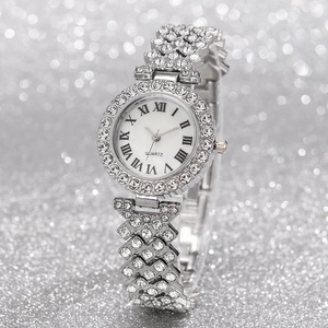 Close-up of silver quartz watch with rhinestone-studded bezel and Roman numeral dial