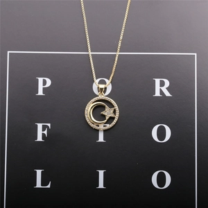 Close-up of golden crescent moon and star pendant necklace with cubic zirconia