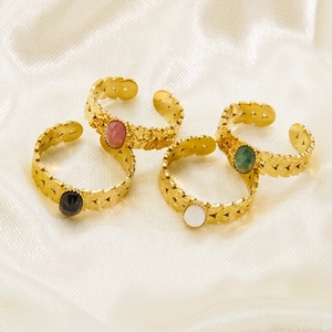 Bohemian adjustable gold-tone rings with colorful natural stones on silk background