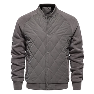 Detail view of dark grey quilted jacket with fleece sleeves and ribbed cuffs