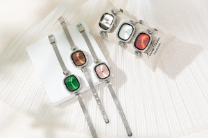 Detail of luxury rhinestone oval watches with colorful dials and mesh steel bands