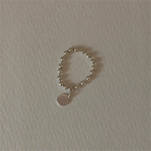 Detailed view of a 925 sterling silver beaded ring featuring a polished round charm pendant