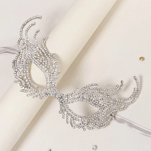 Macro shot of luxurious silver masquerade mask with glittering rhinestones and grey ribbon