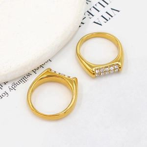 Detailed view of two 18K gold plated stainless steel rings with square zircon stones