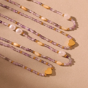 Delicate handmade beaded necklace with purple crystals, pearls and gold heart pendant
