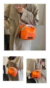Detailed views of an orange nylon crossbody bag with a wide colorful geometric strap