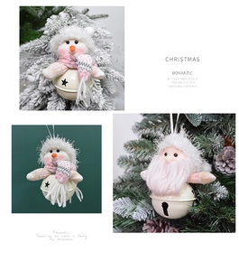 Detail of plush Santa and Snowman pendants on festive pink metal Christmas bells