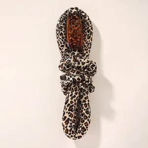 Detailed view of leopard print heatless hair curler set with amber hair claw clip